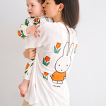 Kvinde iført den Miffy hvide amme-T-shirt med broderet tulipan og ammeåbninger