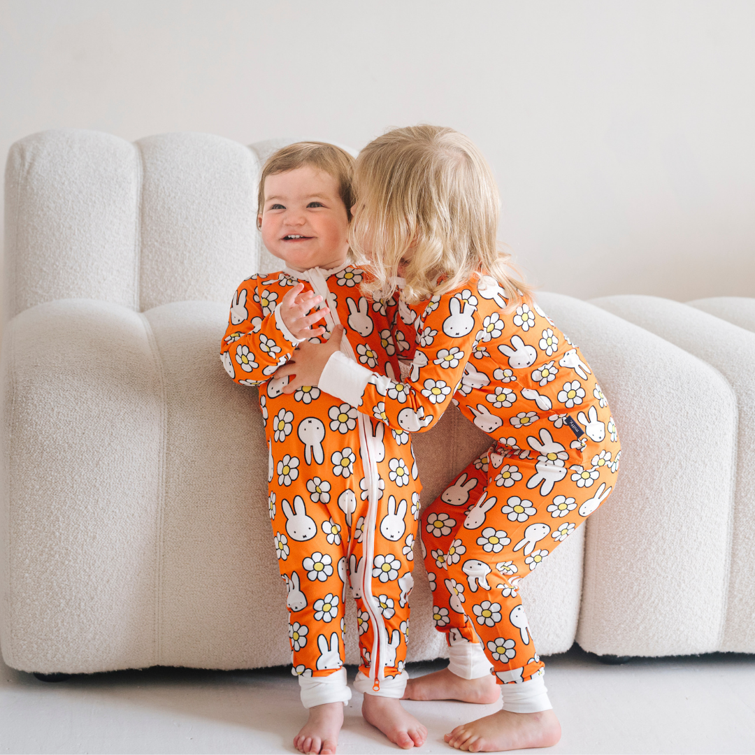 Baby wearing the ZIPSTER x Miffy Daisy Days bamboo babygrow