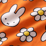 Close-up of the soft bamboo fabric of the ZIPSTER x Miffy Daisy Days bamboo babygrow